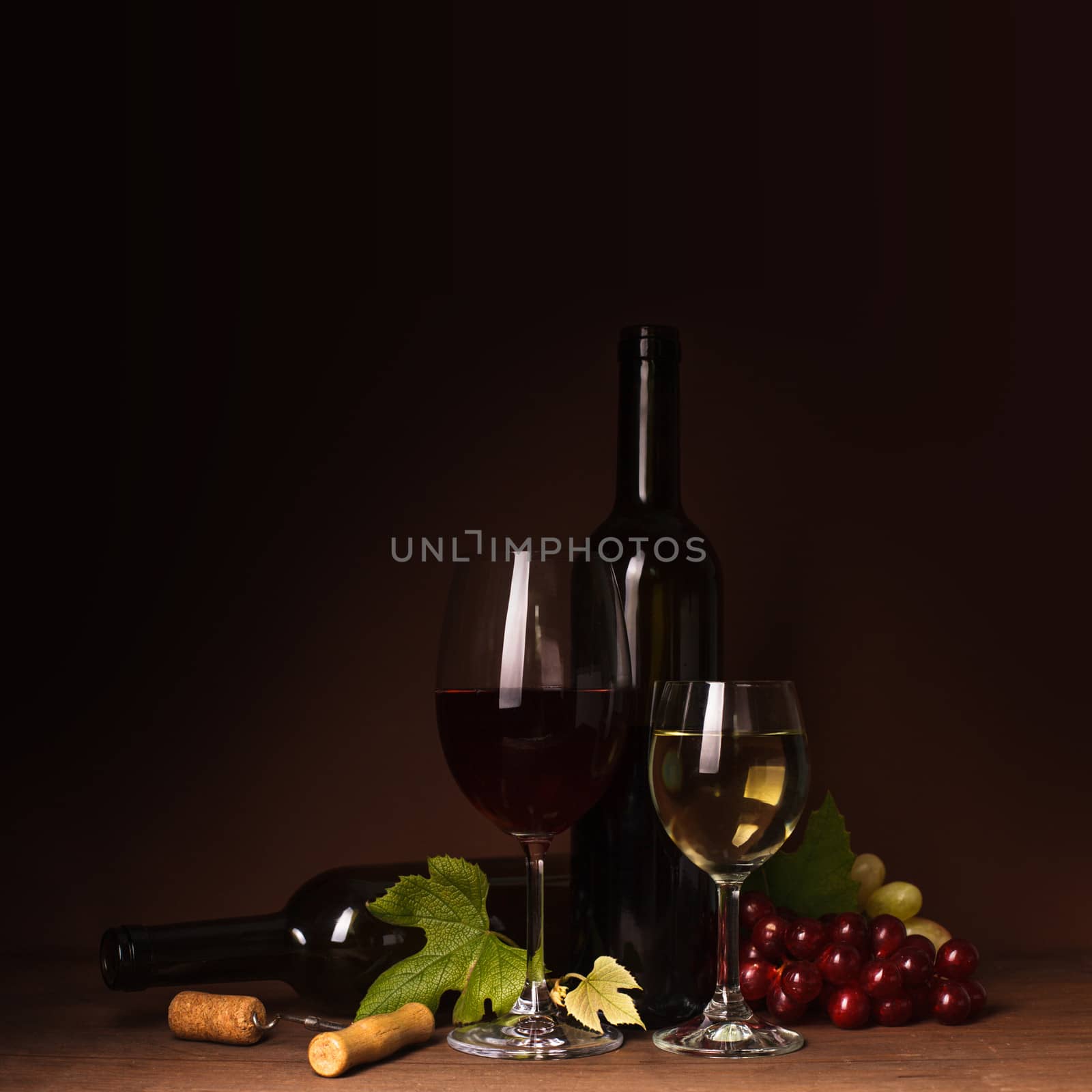 Wine still life: bottles, corks, grapes and glasses