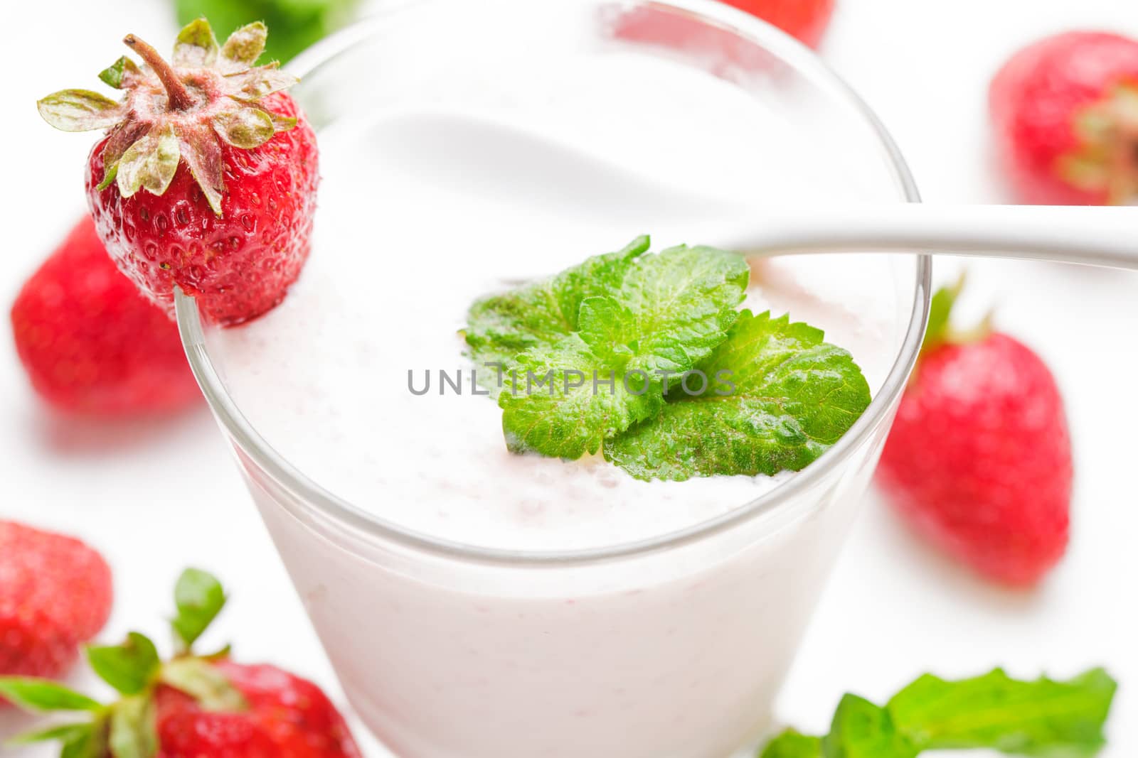 Strawberry yoghurt in glass on the white table