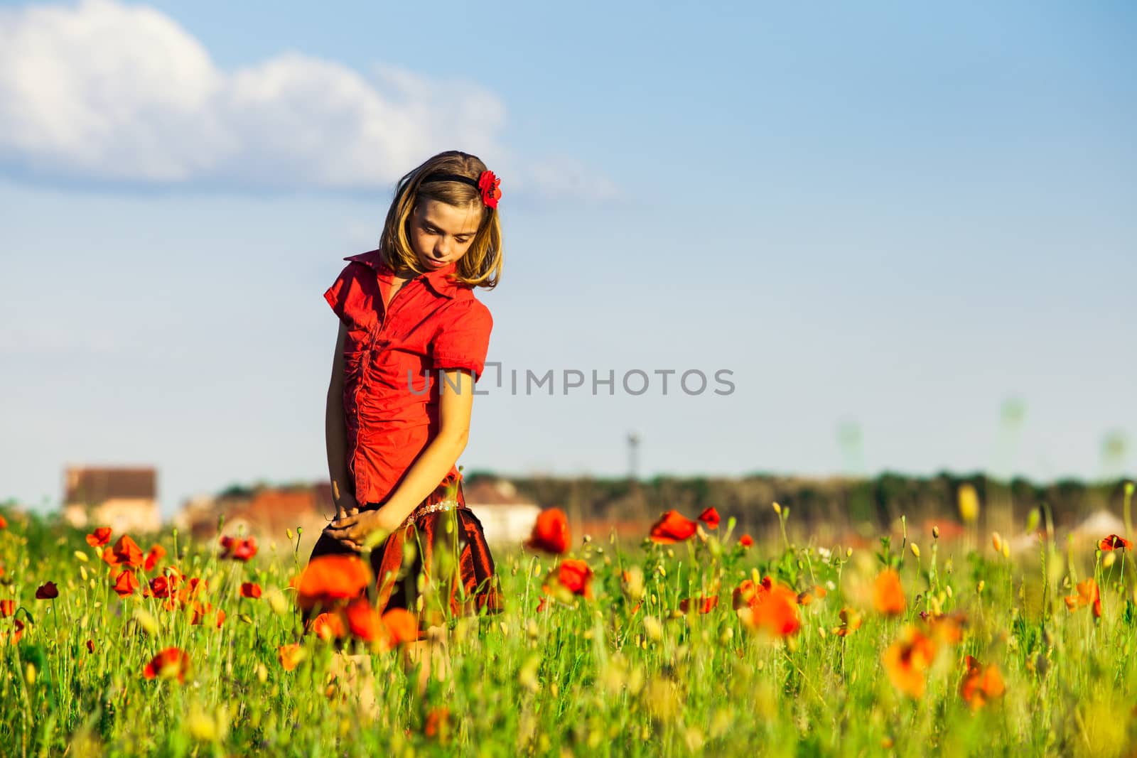 Girl stand with arms outstretched in the poppies field and enjoy the nature