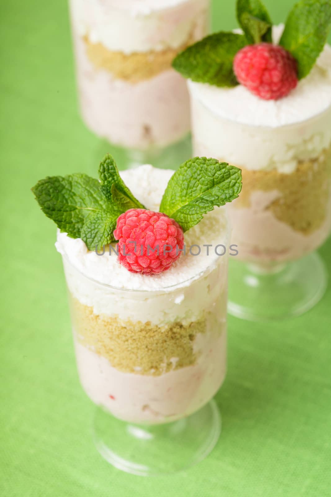 Dessert with raspberry and curd mousse with mint leaves