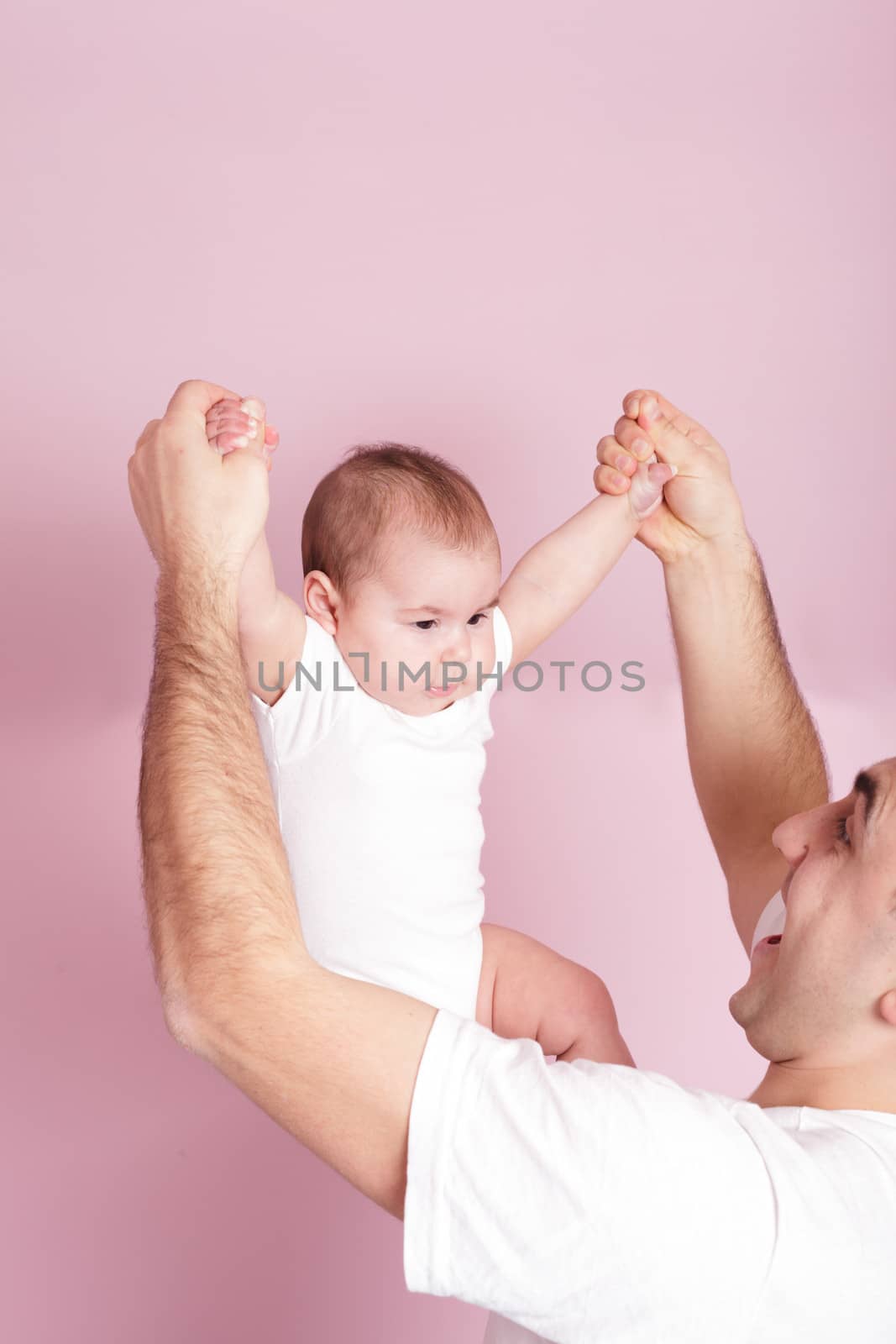 father is doing with baby dynamic gymnastics