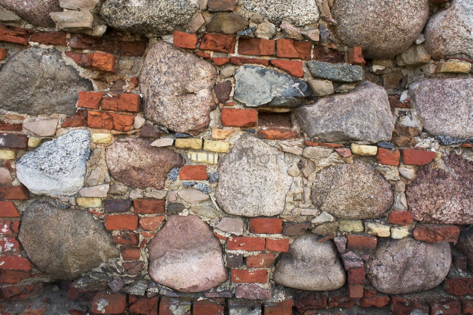 fragment of the old wall of stone and brick