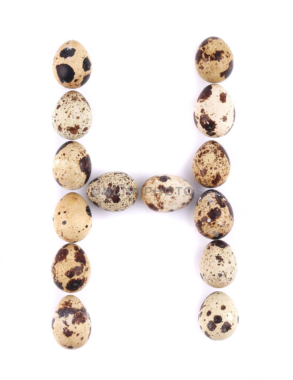 quail eggs in the form of letter H. Isolated on a white background