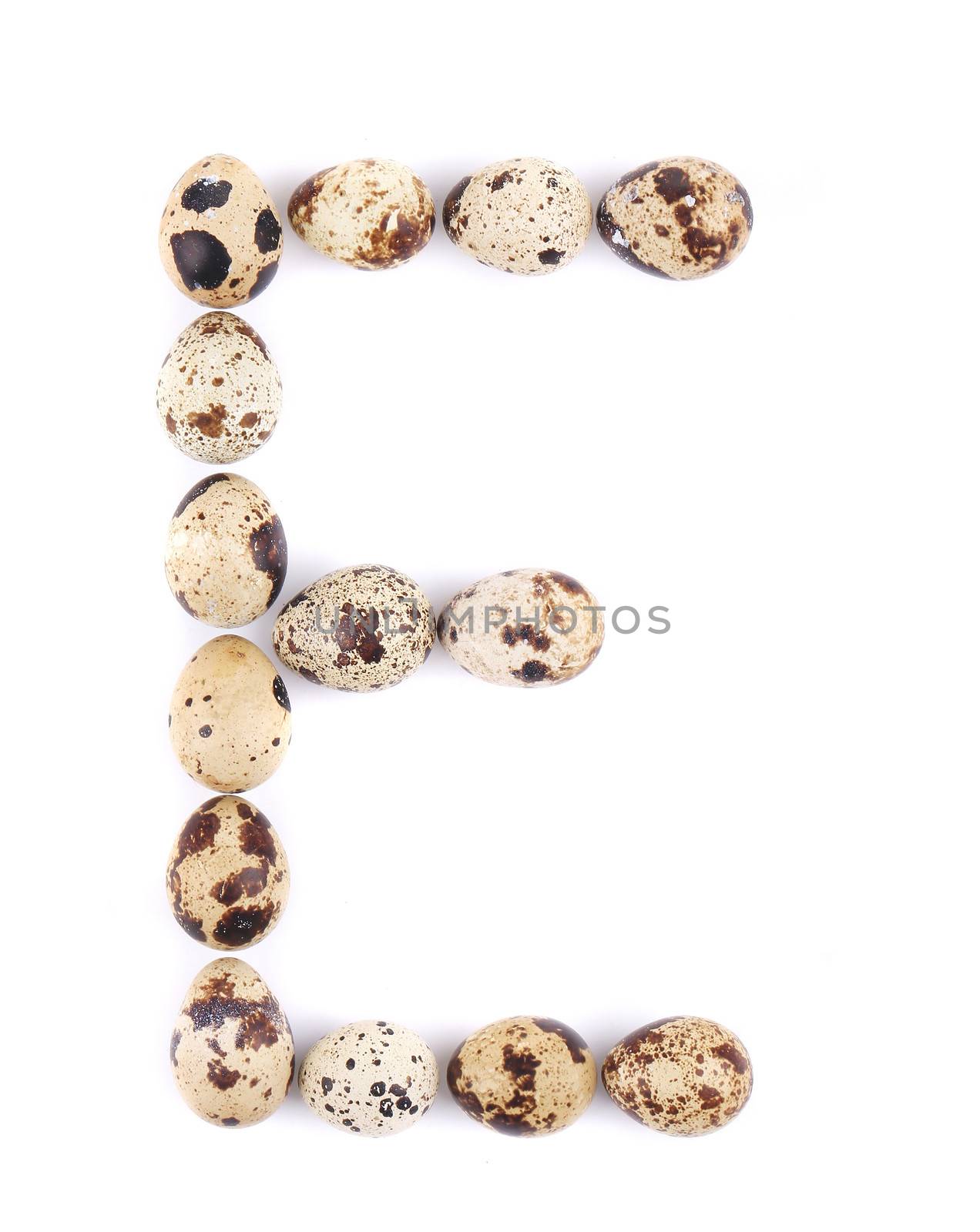quail eggs in the form of letter E. Isolated on a white background