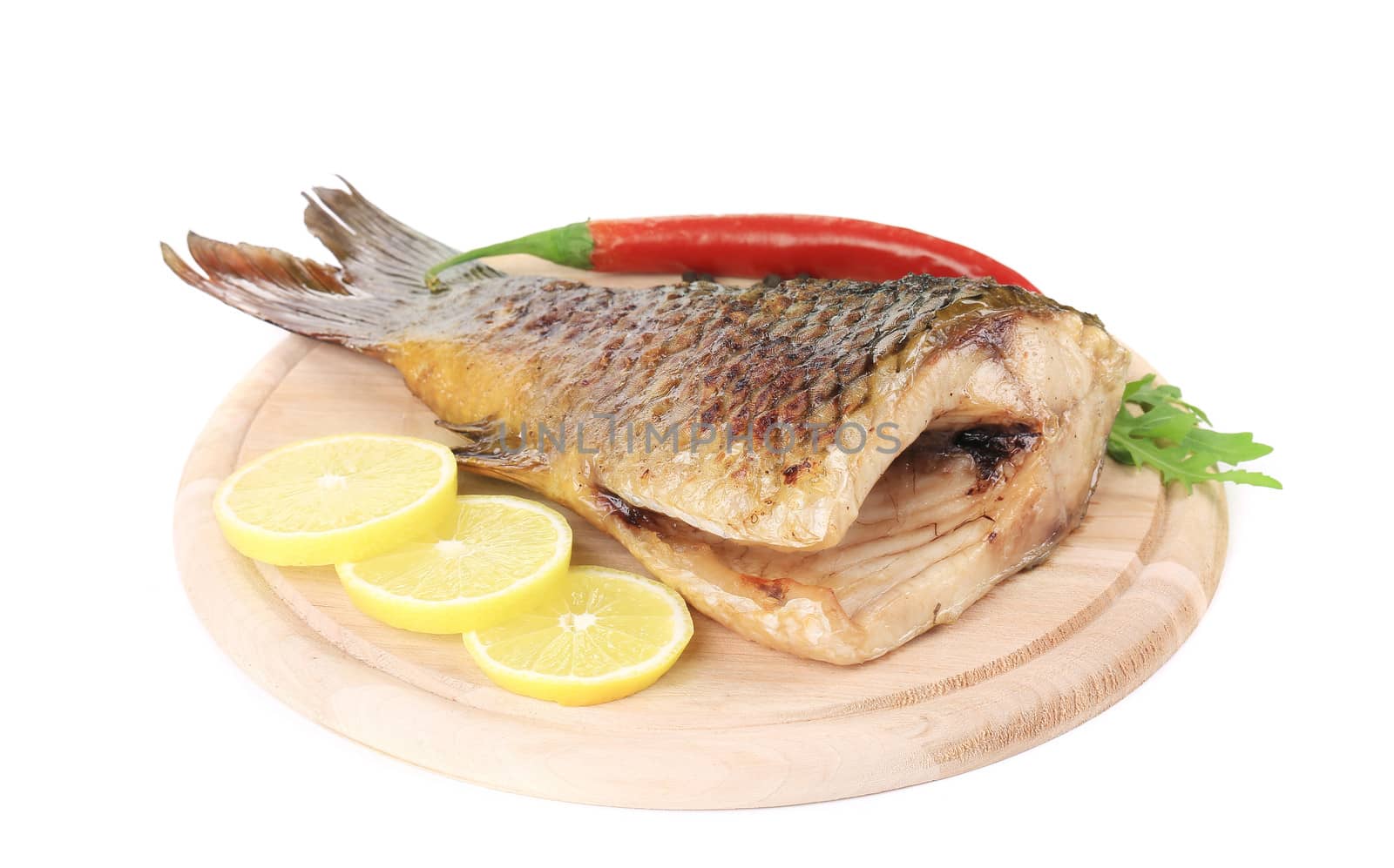 Fried fish tail on wooden table. Isolated on a white background