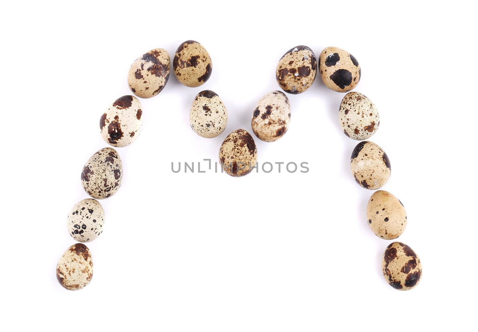 quail eggs in the form of letter M. Isolated on a white background