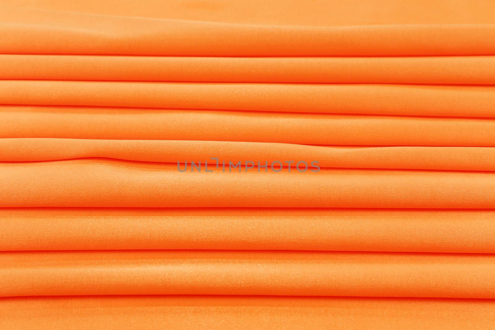 Folded orange silk. To be used as background.