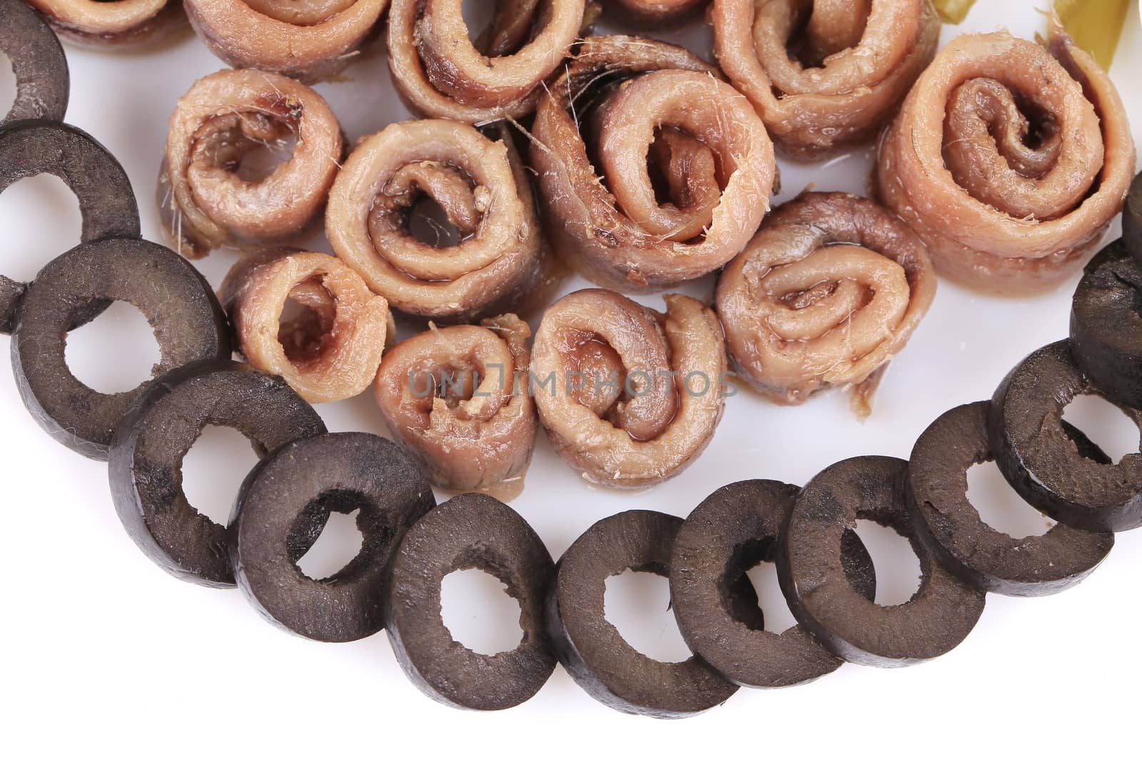 Marinated anchovies with sliced ??black olives. To be used as background.