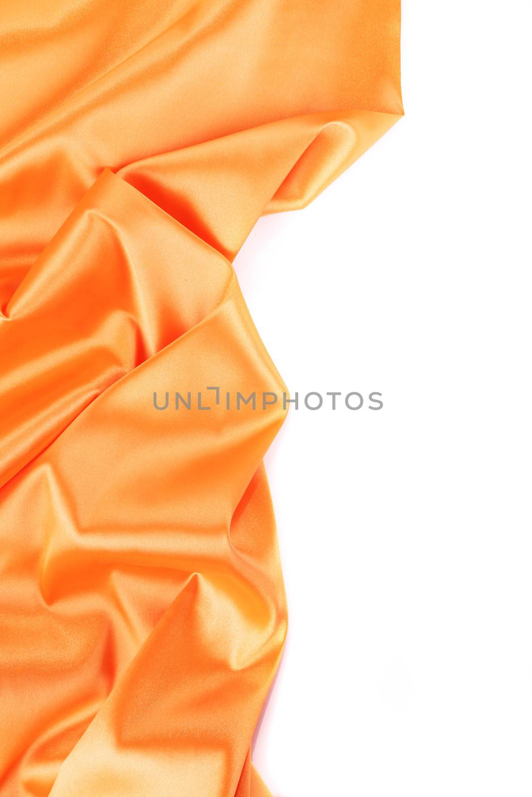 Folds of orange satin. On a white background.