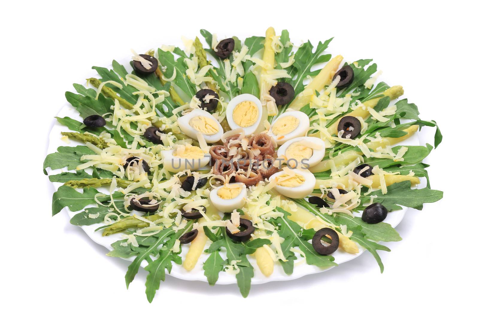 Salad with anchovies and asparagus. On a white background.