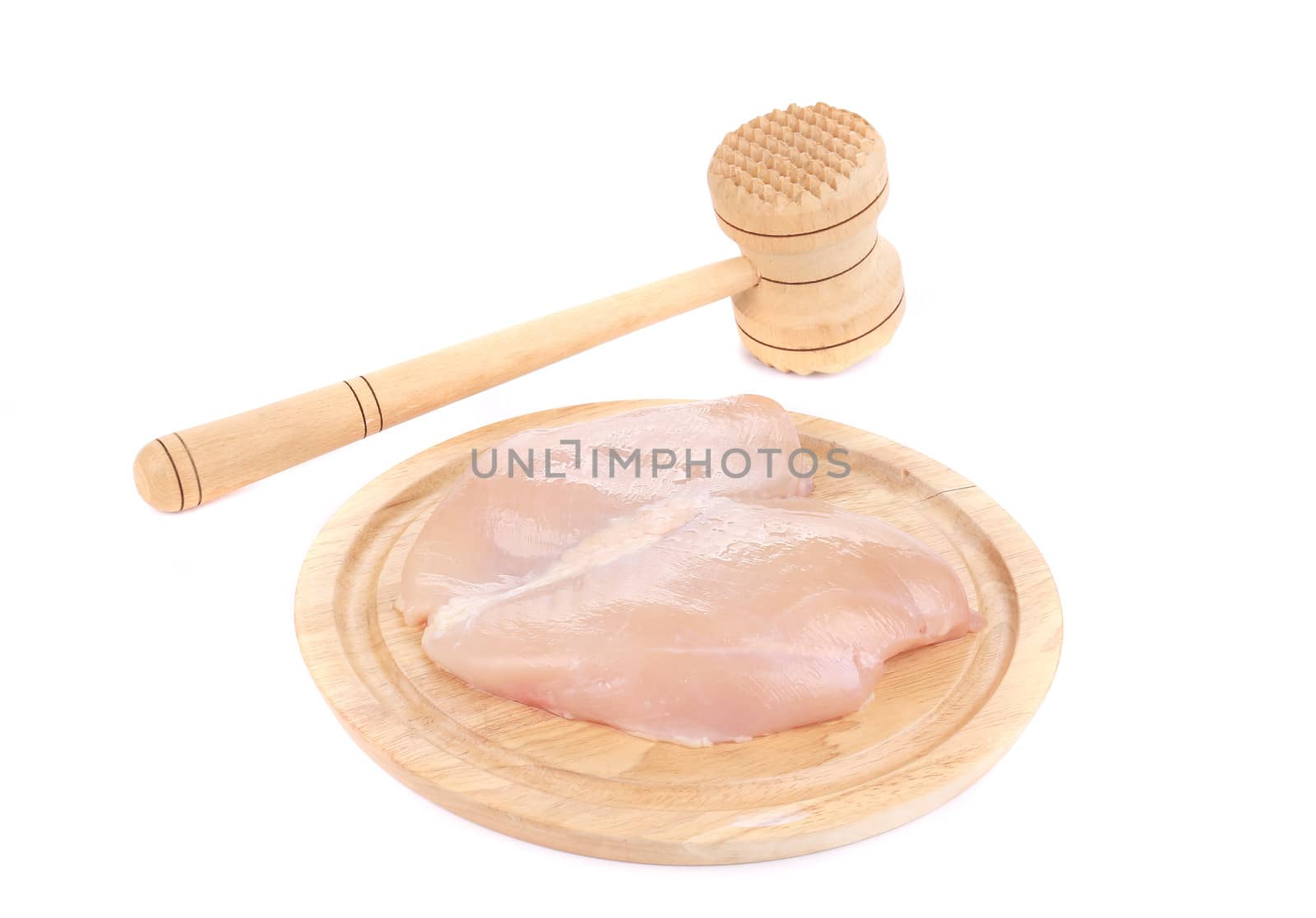 Raw chicken breast and meat mallet on the wooden board. Isolated on a white background
