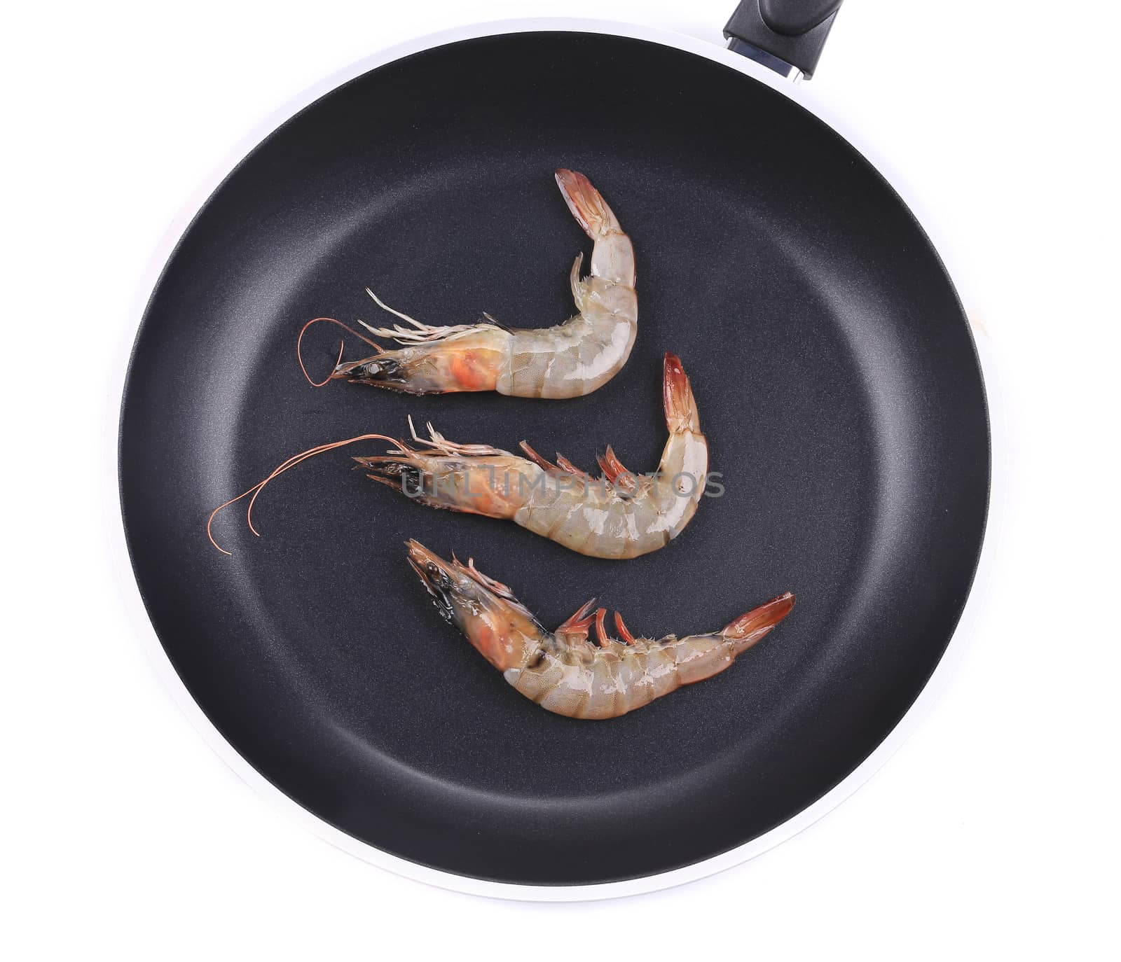 Close up of fresh shrimps on frying pan. Isolated on a white background.