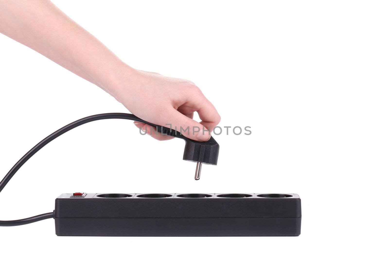 Hand puts the plug in an extension cord isolated on a white background