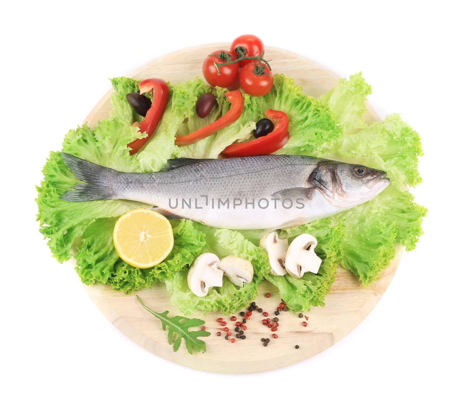 Fresh seabass on platter with lettuce. Isolated on a white background.