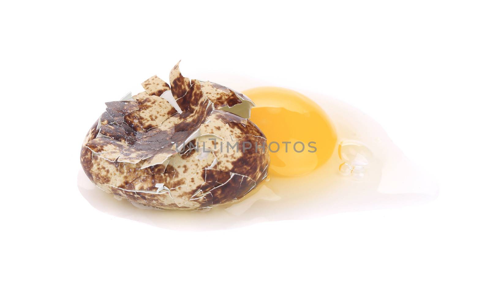 raw broken quail egg. Isolated on a white background