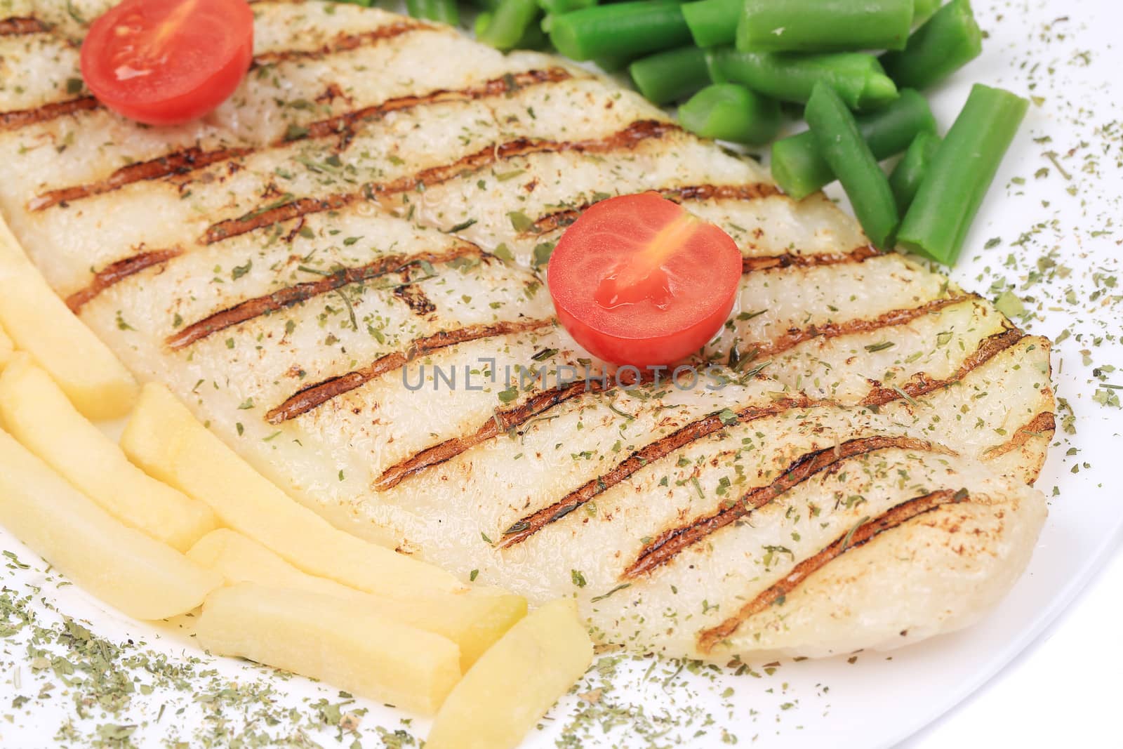 close up of Pangasius fillet grilled with vegetables. Isolated on a white background.