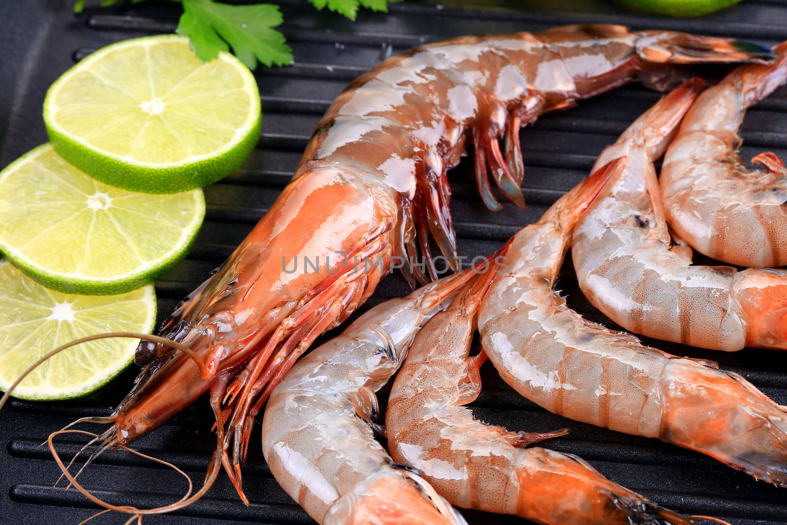 Fresh shrimps on a grill. Whole background.