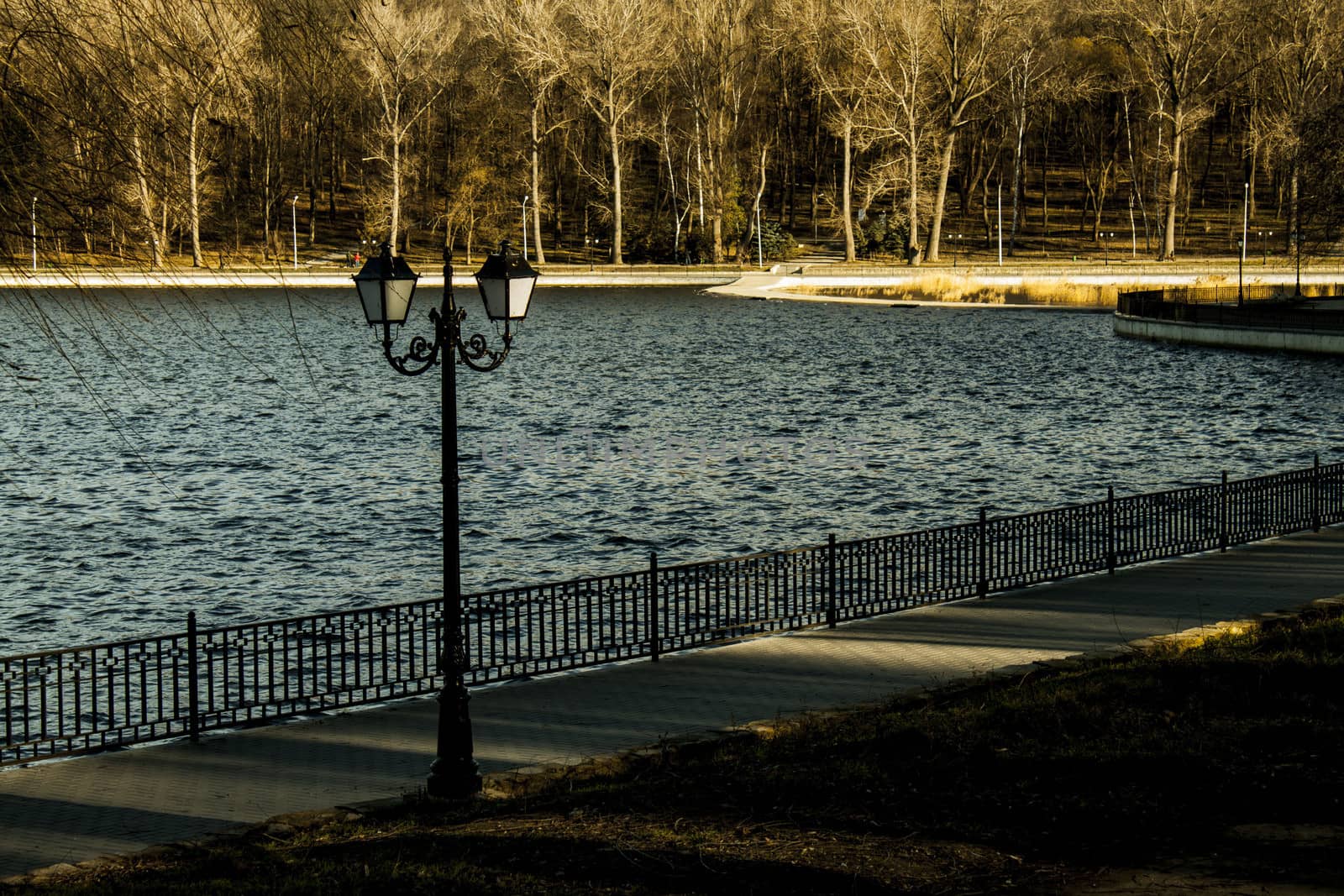 pier with lanterns on the autumn lake