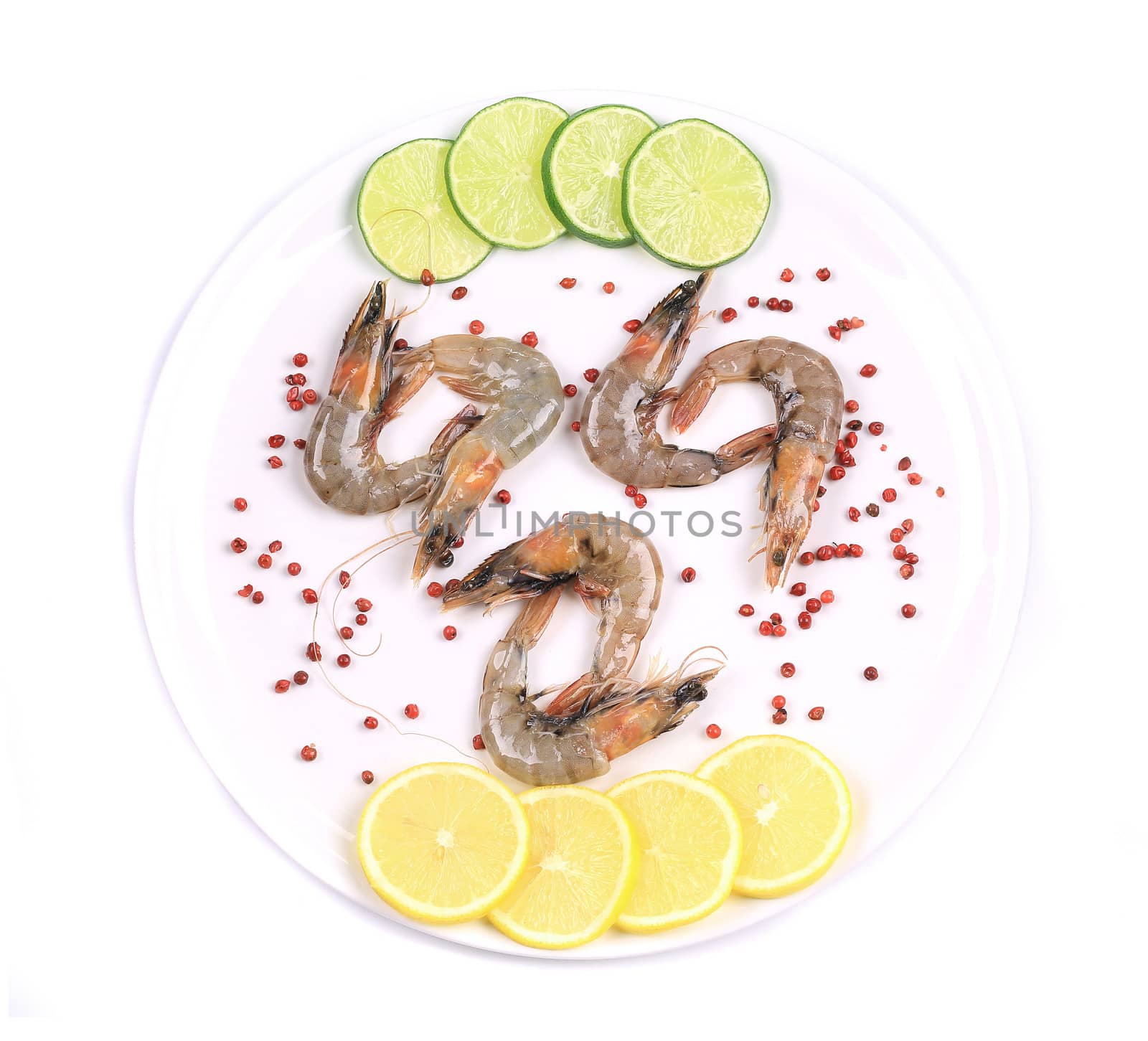 Raw shrimps on plate. Close up. Isolated on a white background.