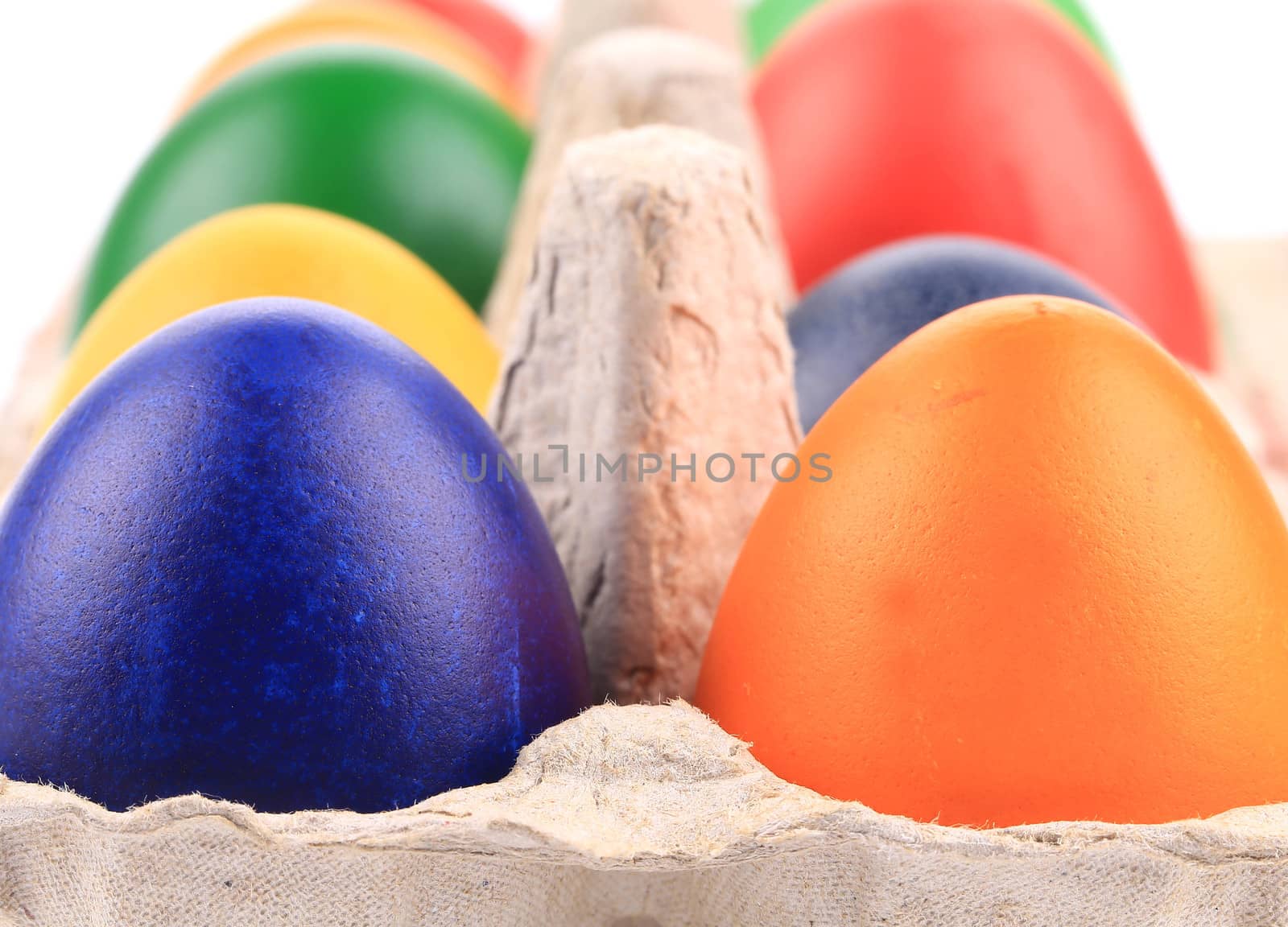 Cardboard egg box with colorful eggs. Whole background.