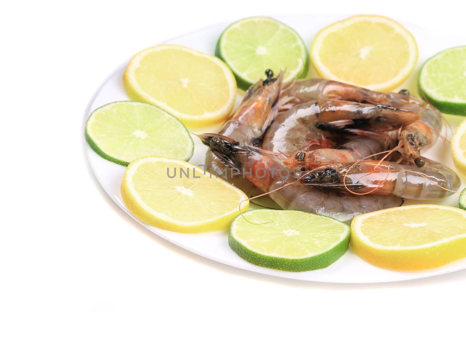 Raw shrimps on plate. Isolated on a white background.