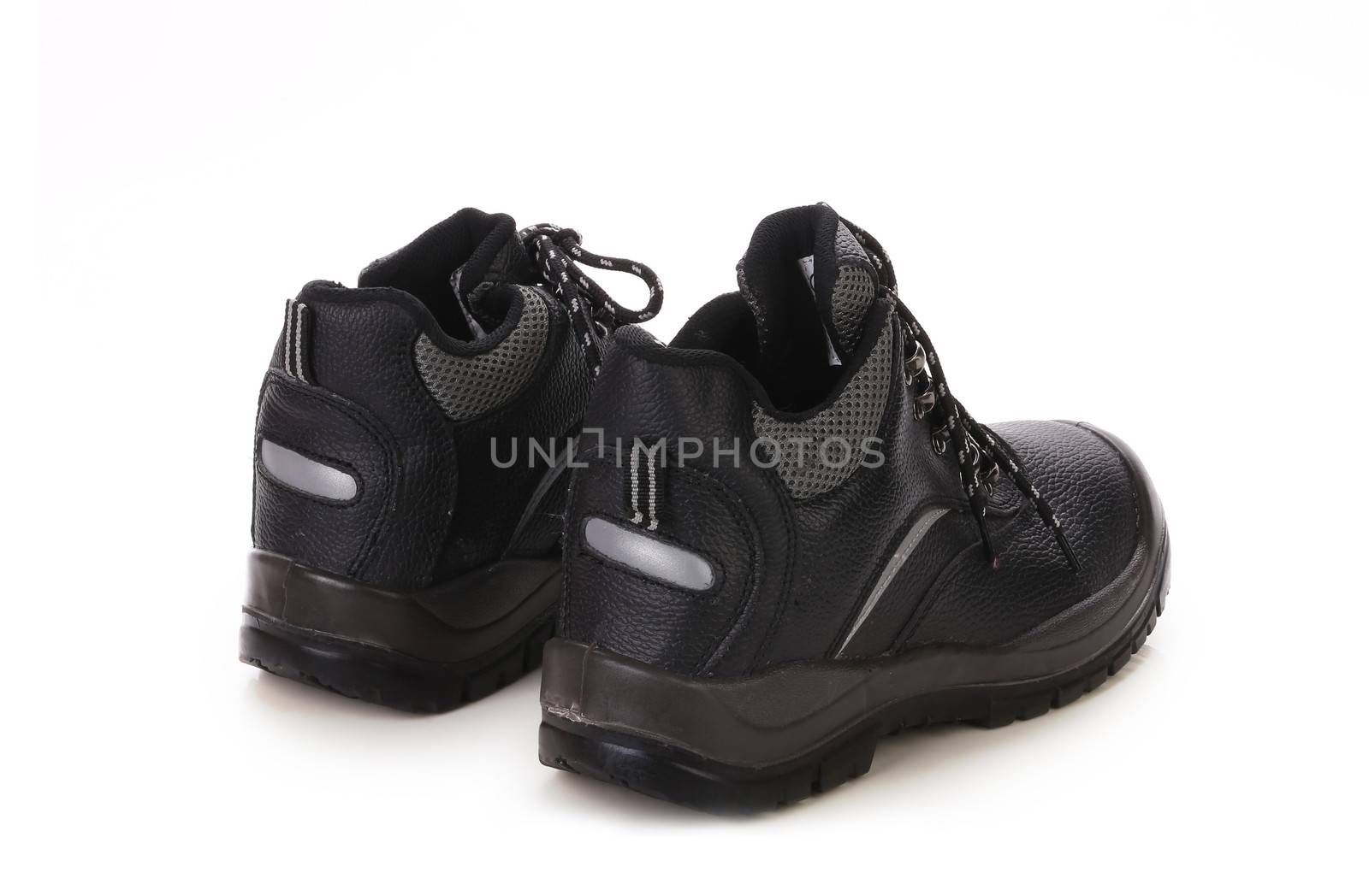 Close up of black shoes with gray spot. Isolated on a white background.