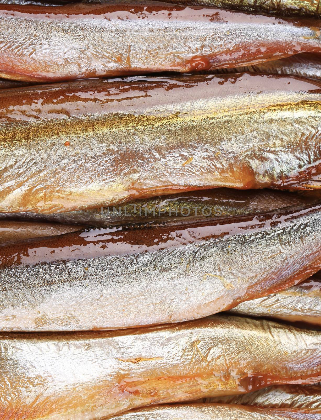 Smoke-dried fish close up. Texture. Whole background.