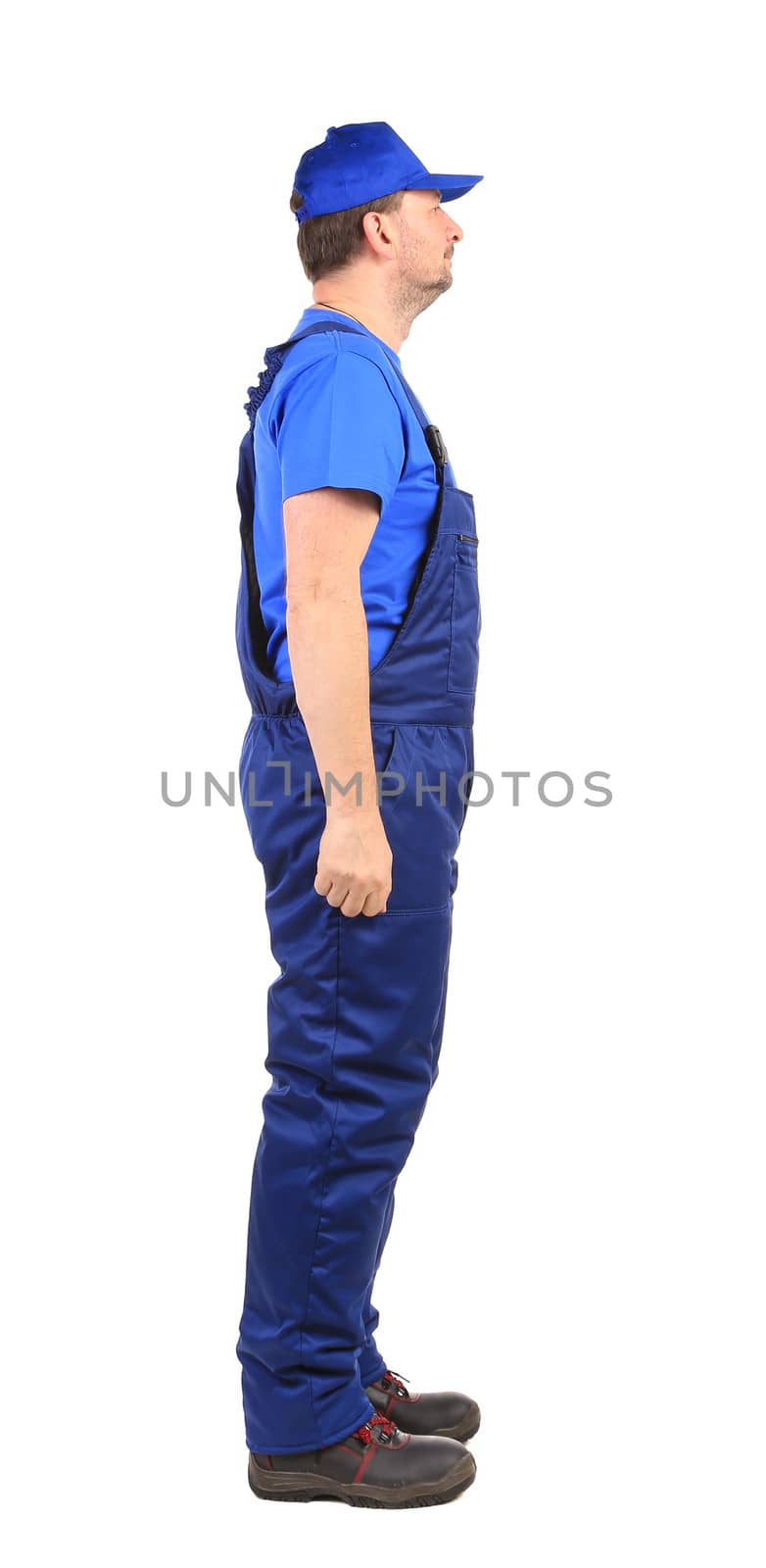 Worker in blue overalls. Side view. Isolated on a white background.