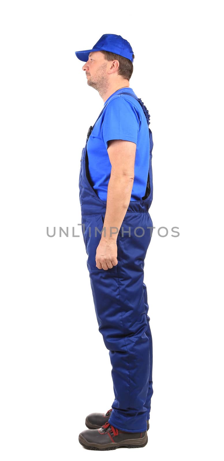 Worker in blue overalls. Side view. Isolated on a white background.