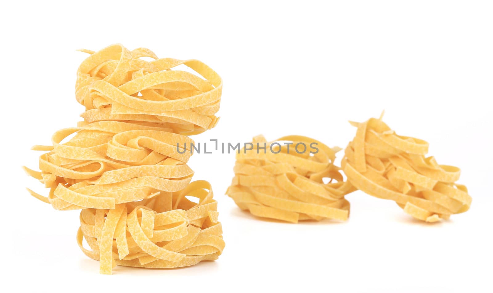 Tagliatelle paglia italian pasta. Isolated on a white background.