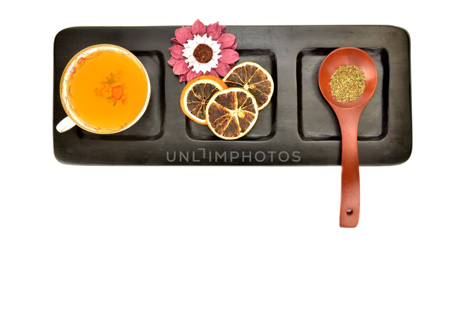 teacup wooden spoon with tea and dried orange on wooden tray isolated on white background