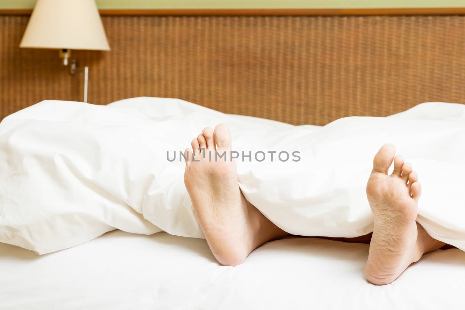 two feet in a bed