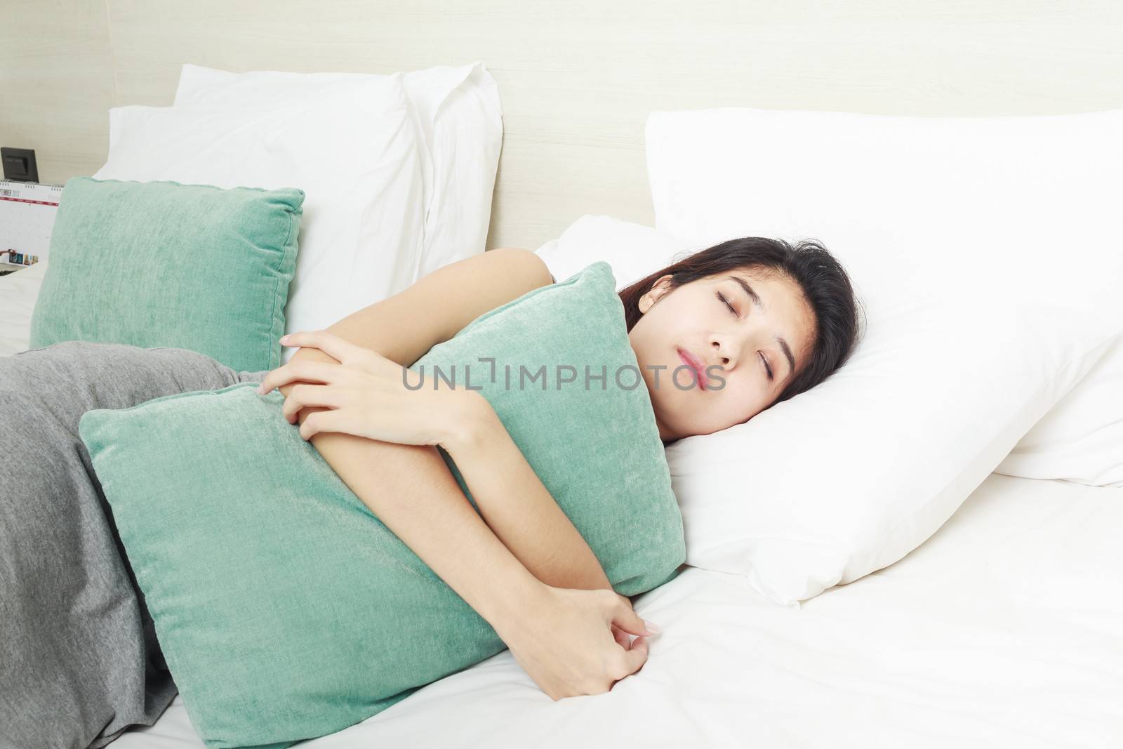 young beautiful Asian woman sleeping in bed by FrameAngel