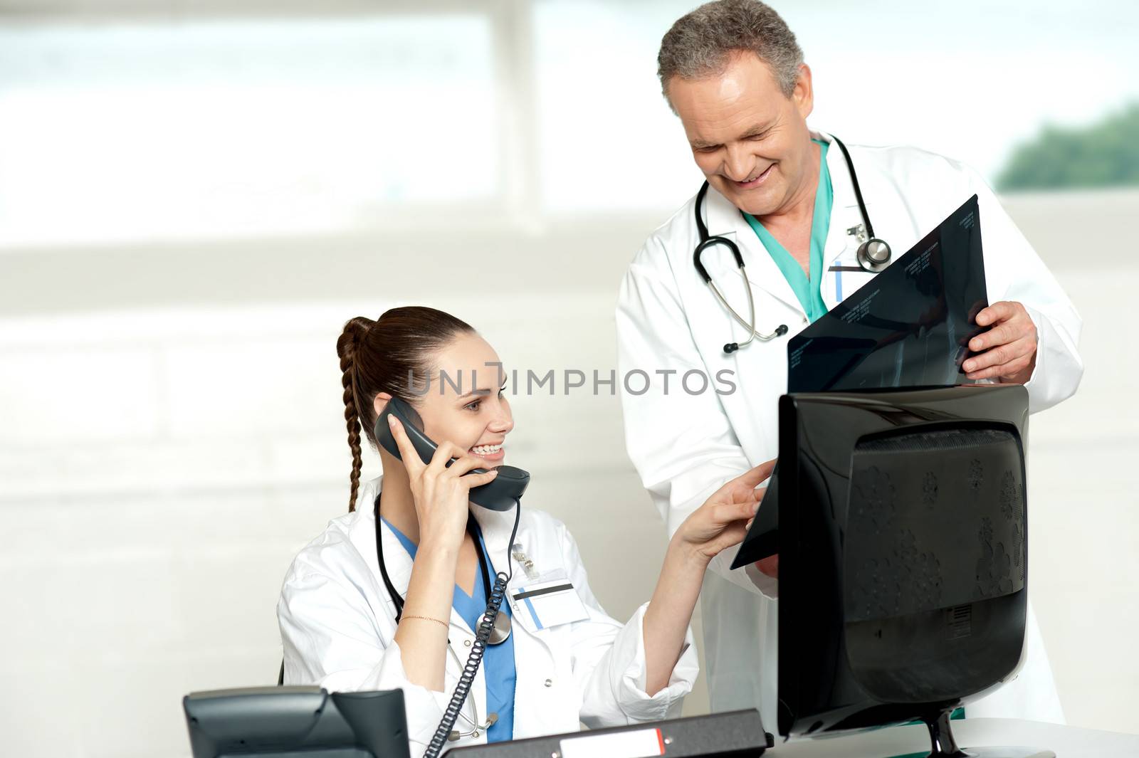 Doctors reviewing patients x-ray report by stockyimages