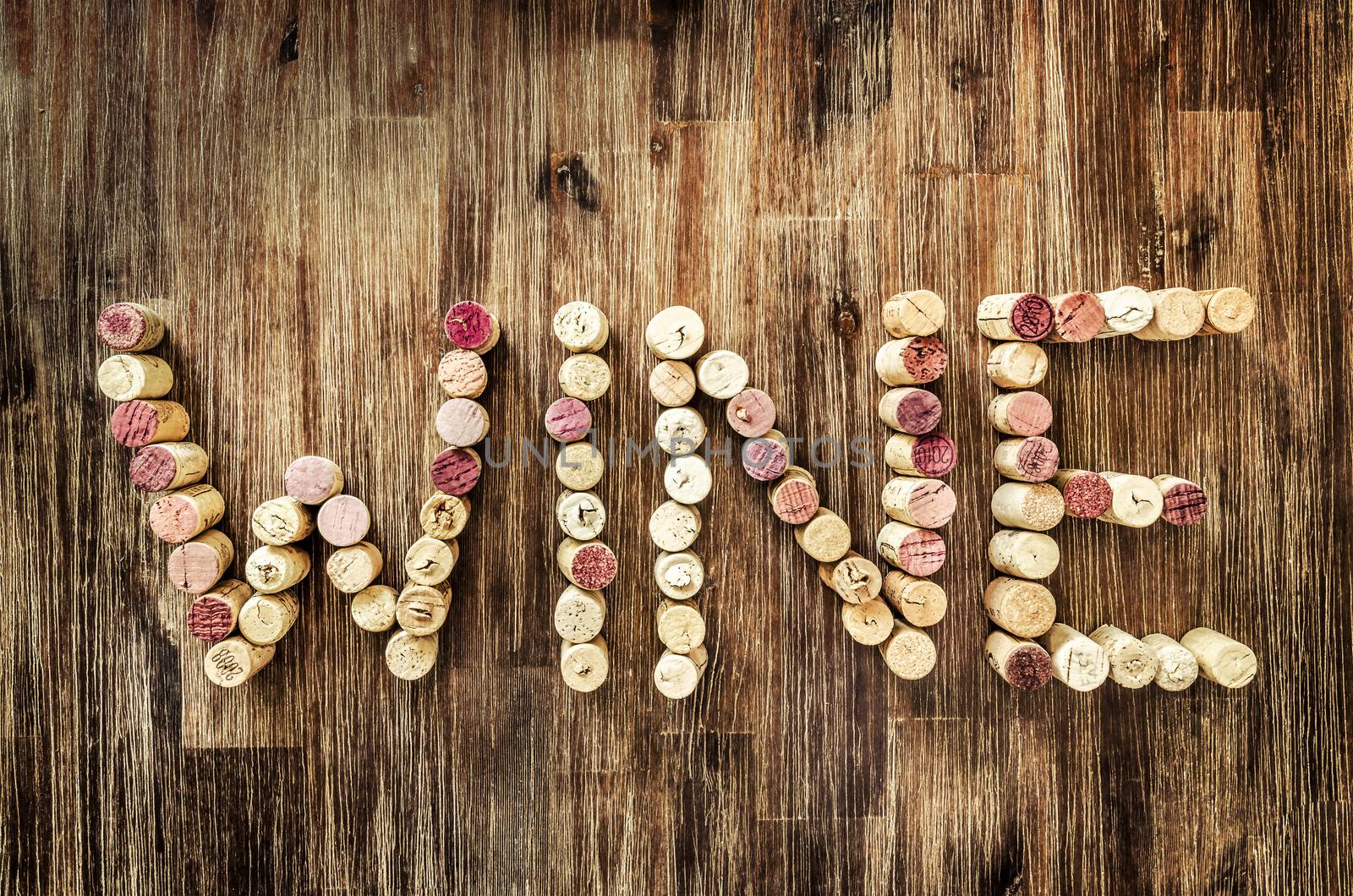 Sign wine made from corks laid on wooden vintage table