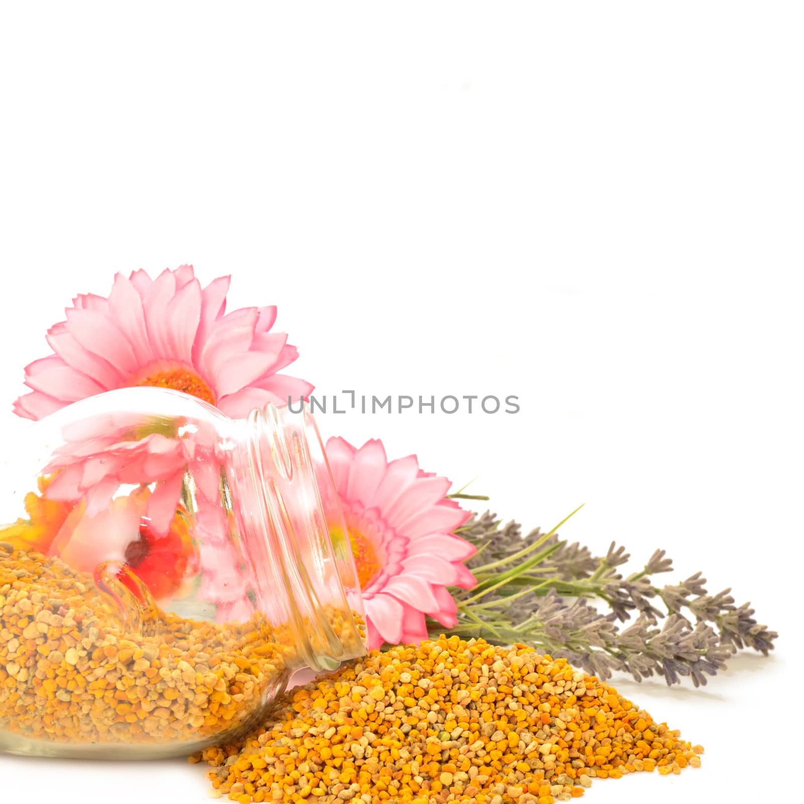 Bee pollen in glass jar and flowers copy space for text