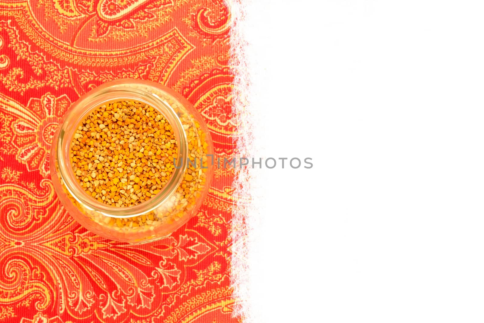 Bee pollen in glass jars on rustic fabric with blank space for text