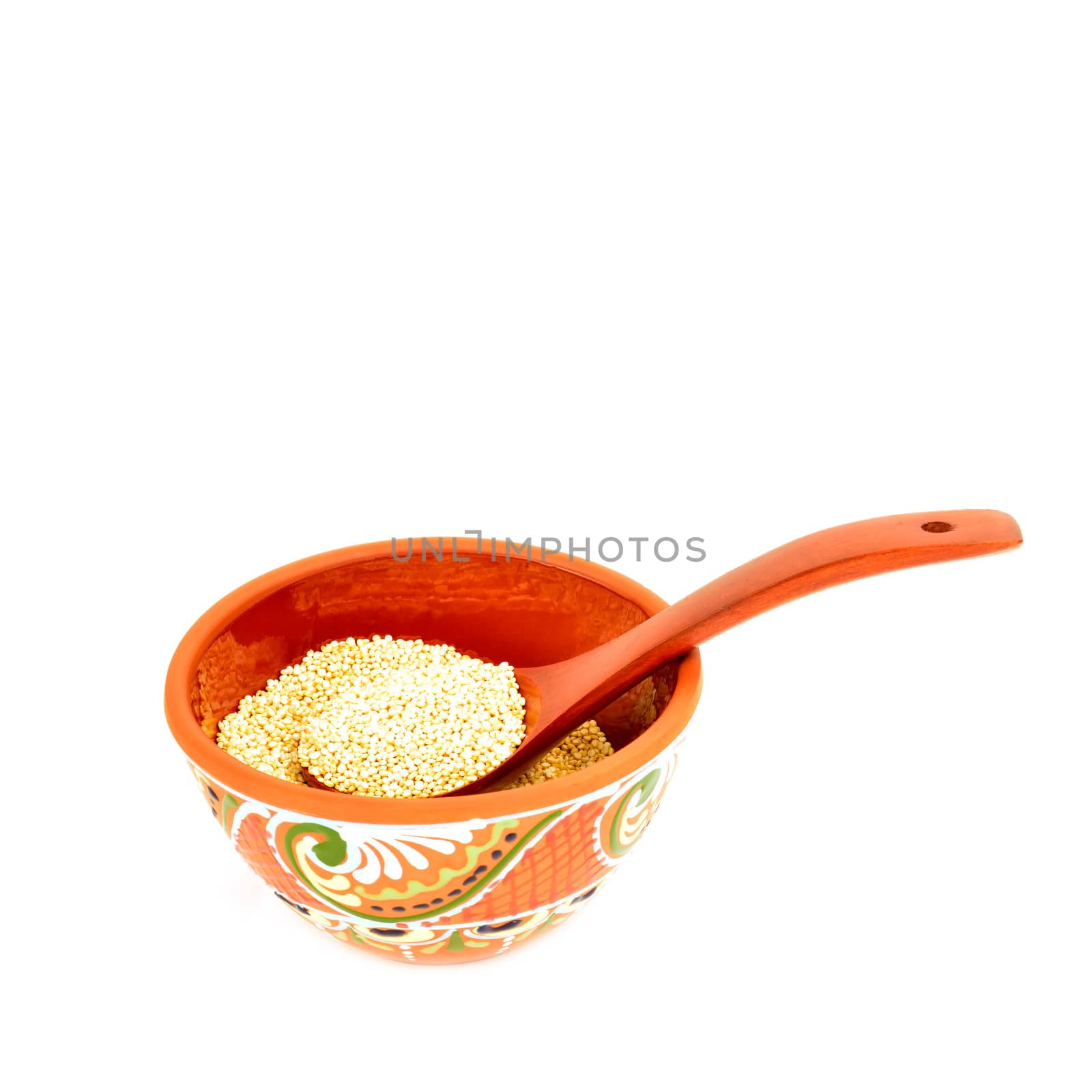 quinoa in clay bowl and wooden spoon isolated on white background