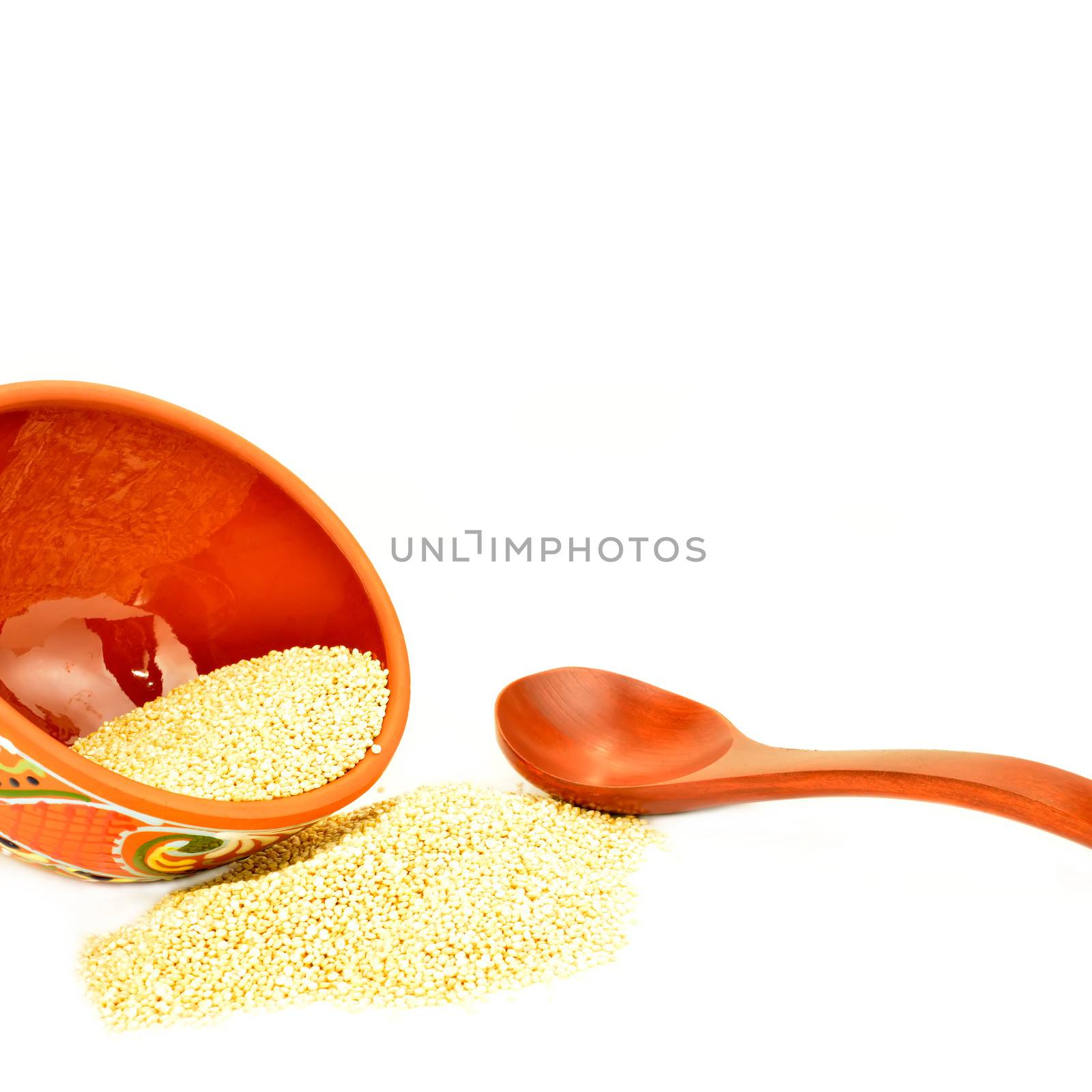 quinoa in ceramic bowl and wooden spoon isolated  by Carche