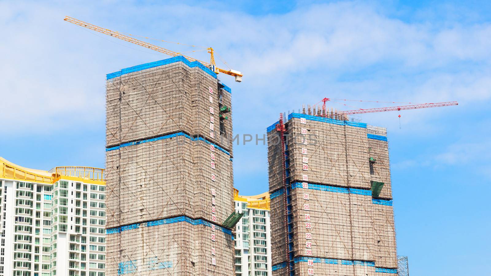 building under construction site and blue sky, wrap for safety