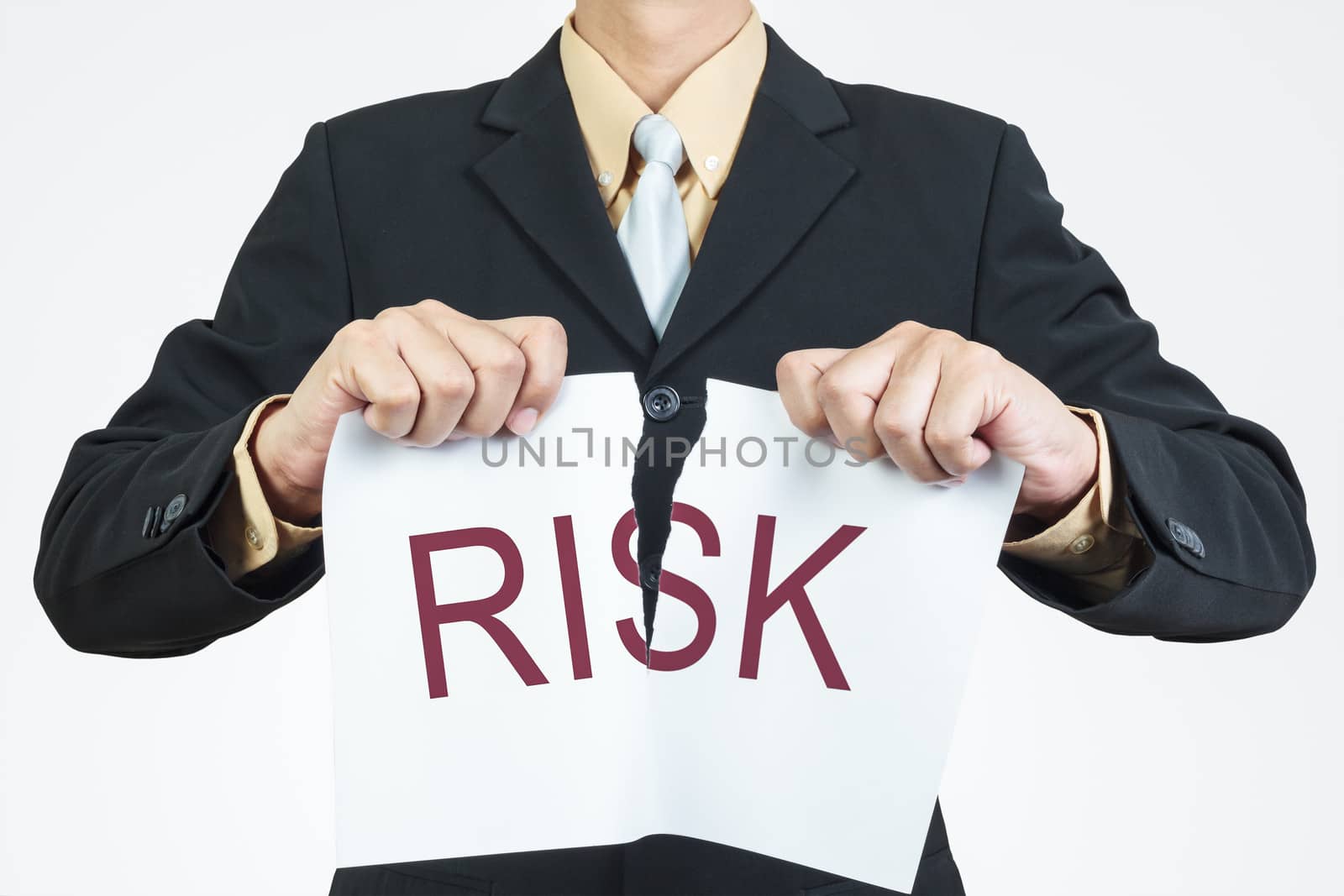 Businessman tearing sheet paper, risk management concept