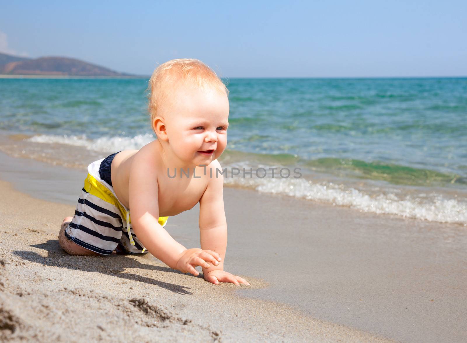 Baby boy playing on a beach