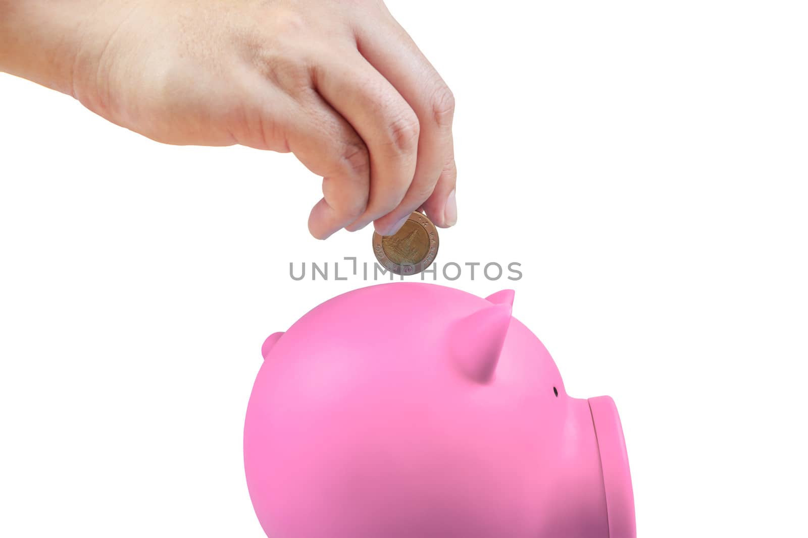 Saving money, hand putting coin into piggy bank