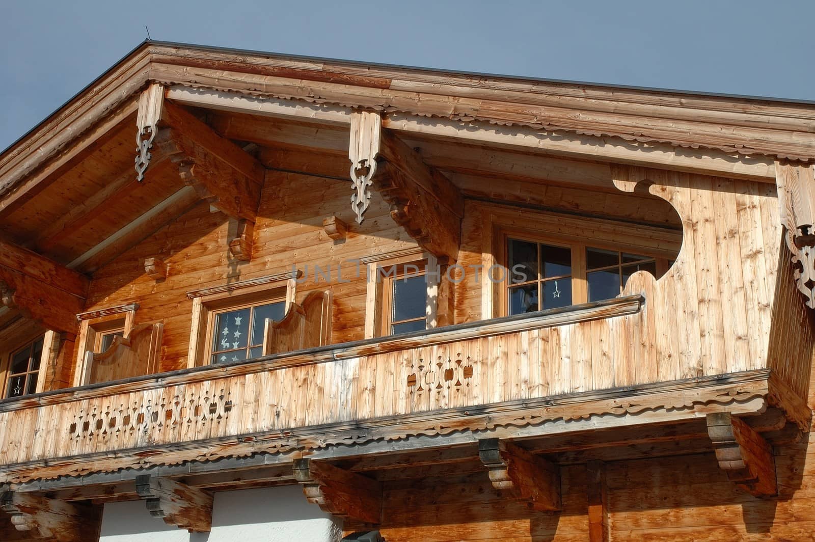 Brown wooden house wall, balcony and windows