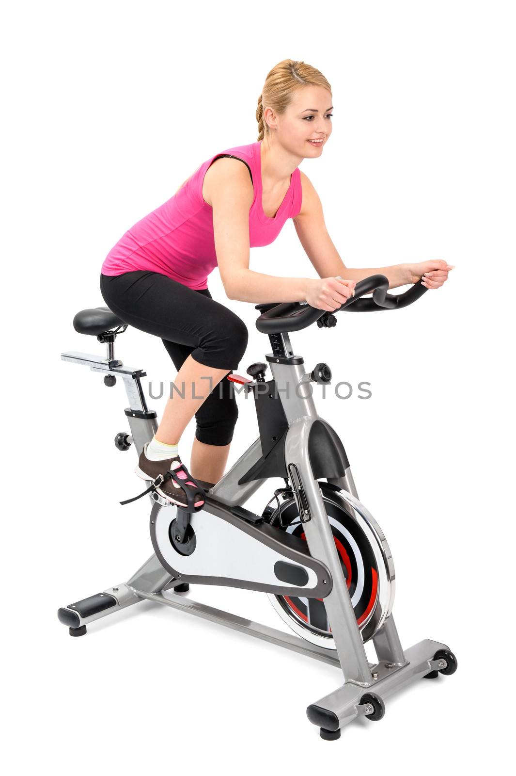 young woman doing indoor biking exercise on spinner