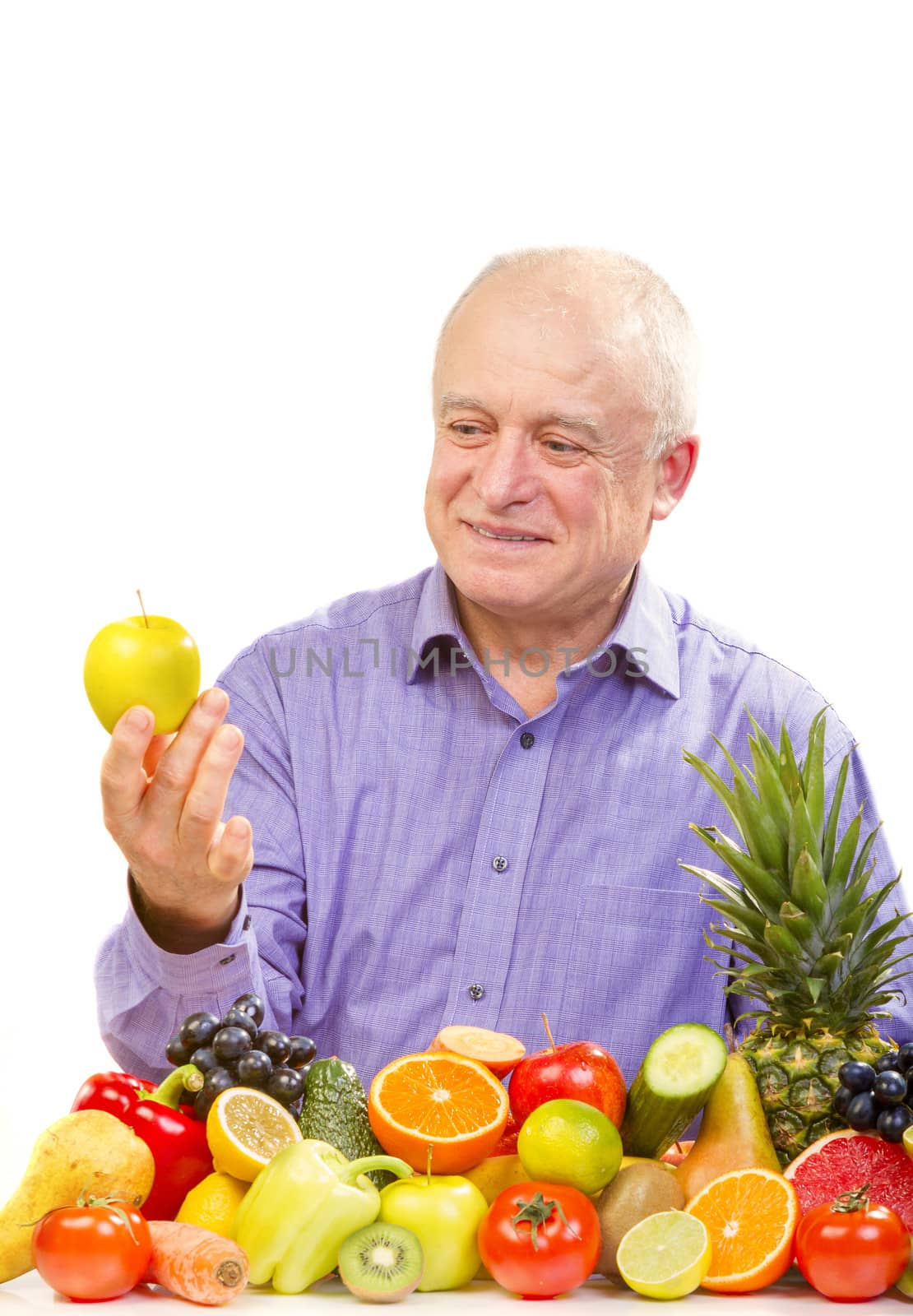 Closeup of senior man holding a green apple