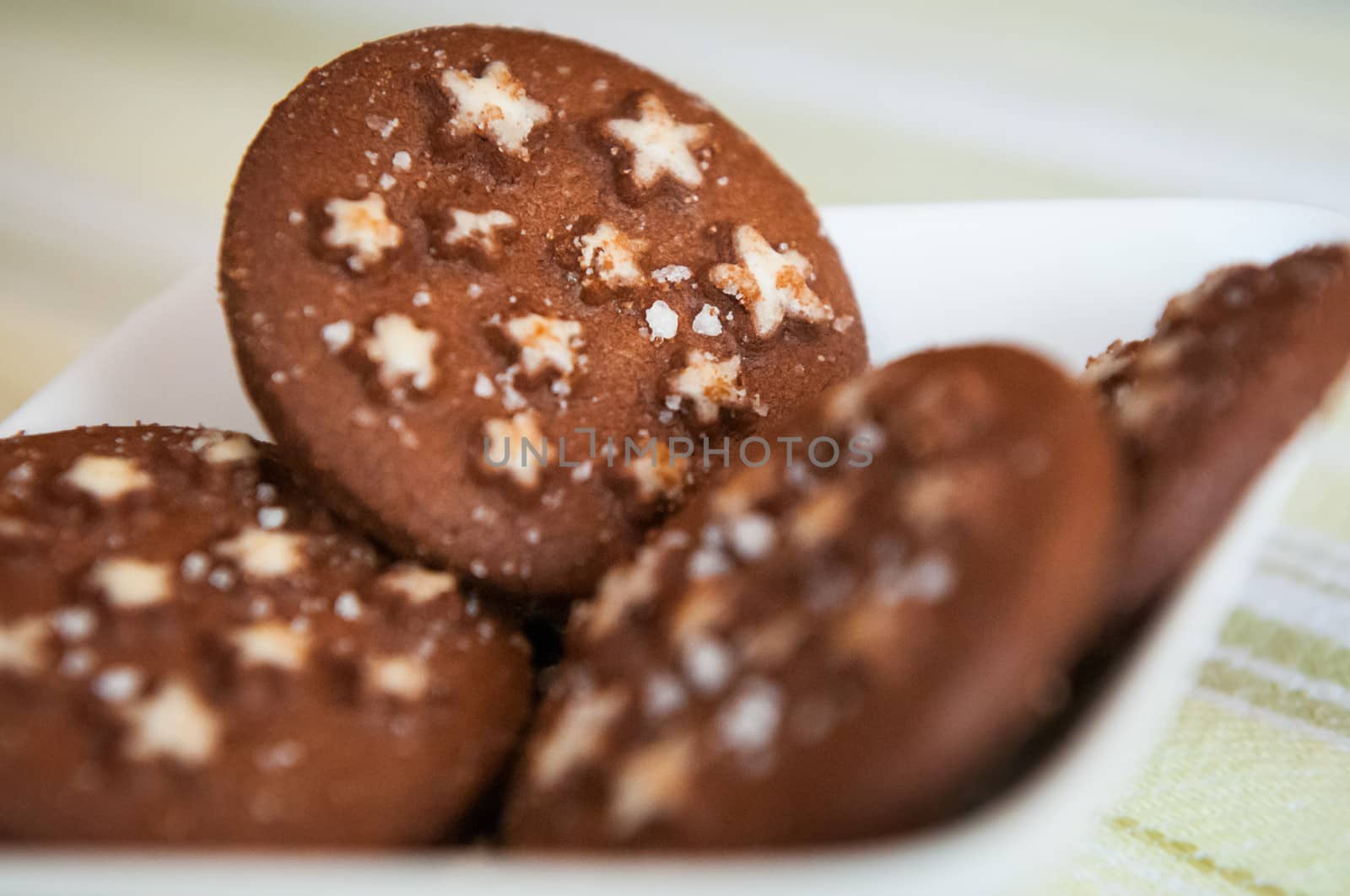 Detail of Christmas holiday dark chocolate cookies with white stars