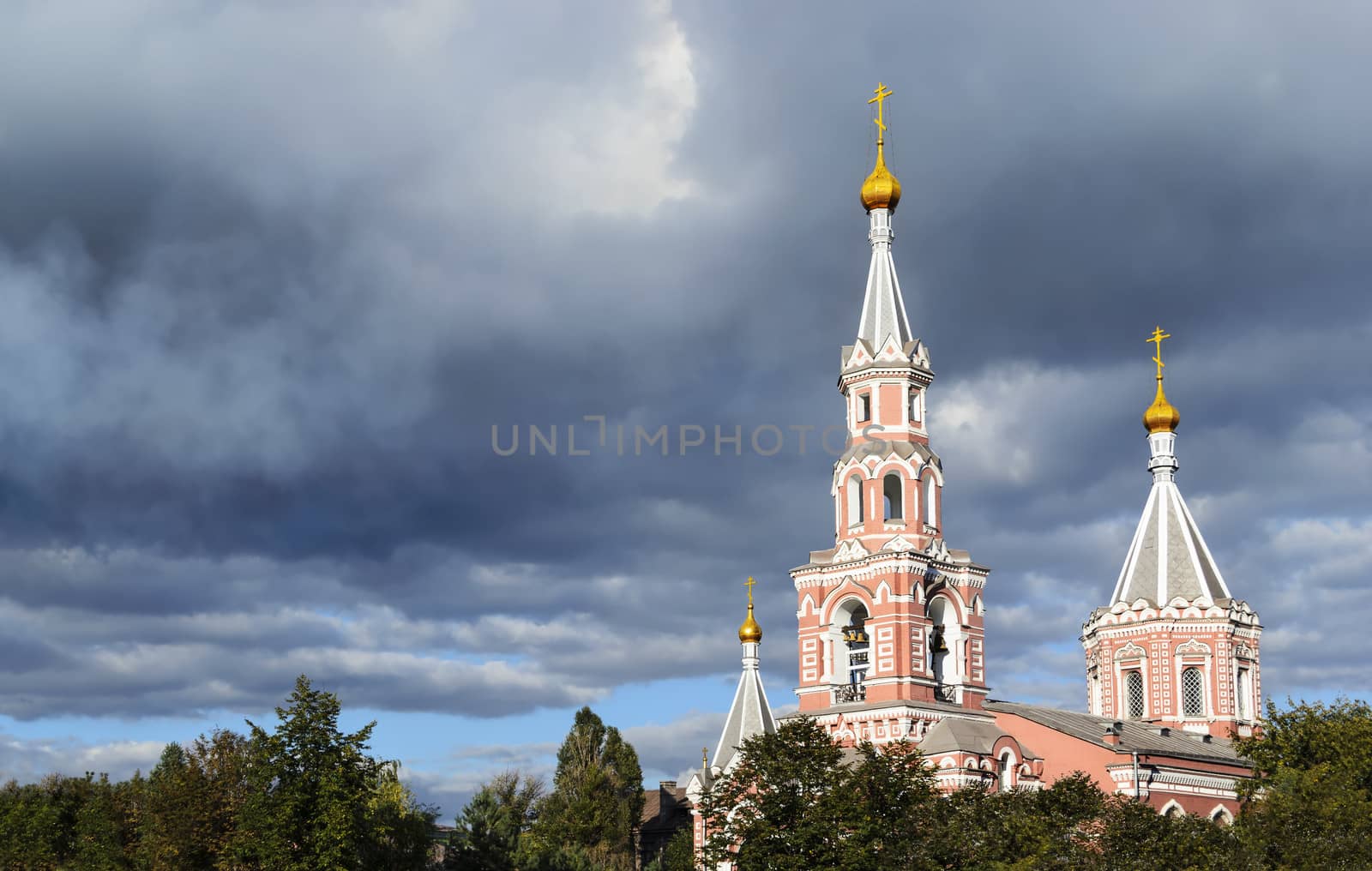 Christian church against the sky with dark clouds. Dniprodzerzhyns'k, Ukraine.