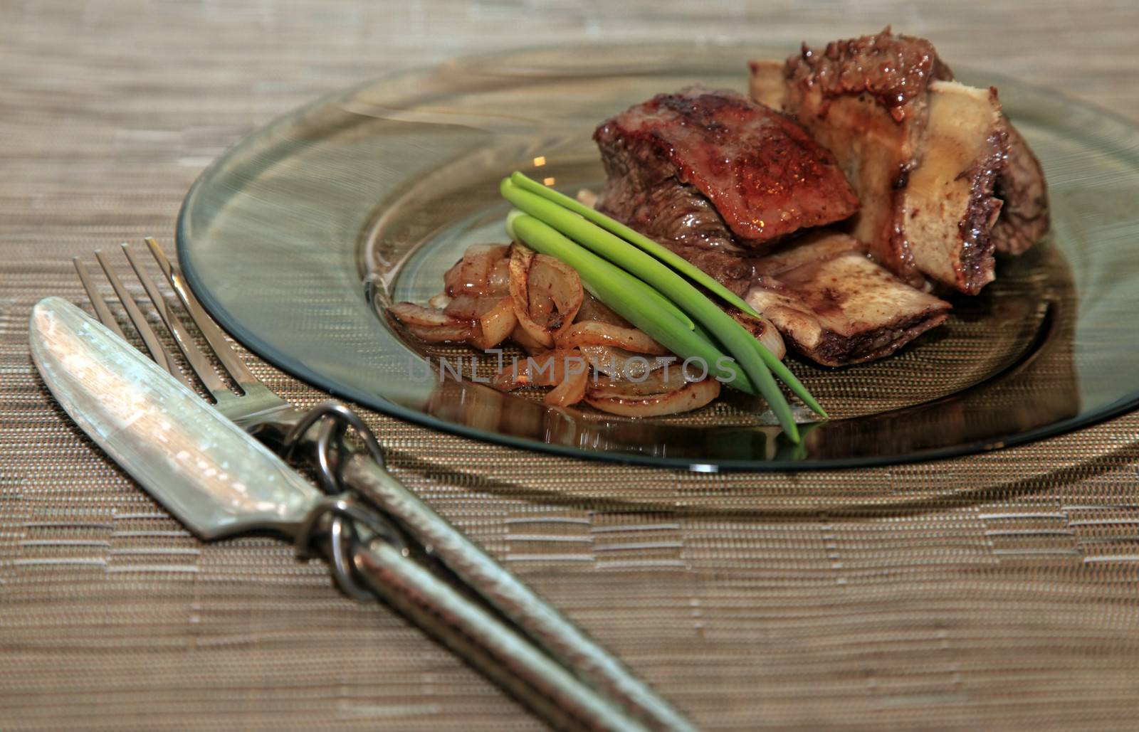 Roast red beef meat bbq bloc served on black plate with green chives