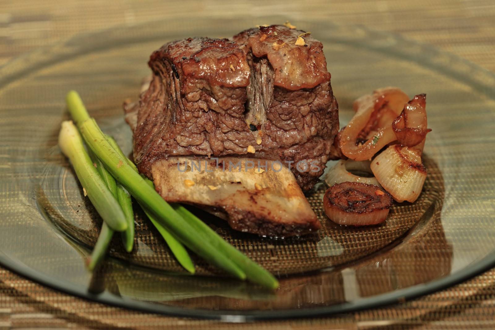 Roast red beef meat bbq bloc served on black plate with green chives